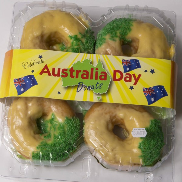 a packet of 4 green and gold doughnuts for Australia Day